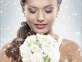 Young attractive bride with the bouquet of white roses over snowy Christmas background